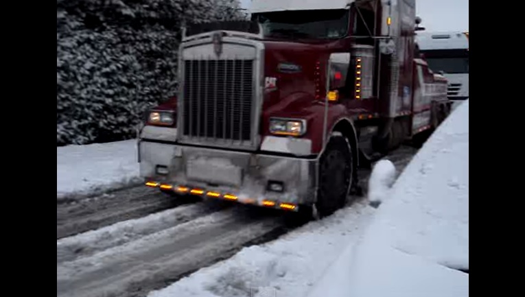 Stuck In Snow And Need A Hand This Big Rig Truck Can Pull 18 Wheeler Uphill Like Nothing!