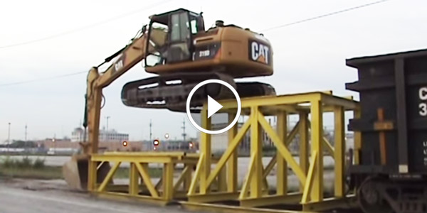 Cat 319D LN climbing onto rail car