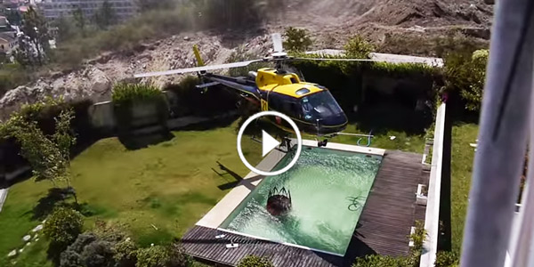 Amazing firefighter helicopter pilot taking water from swimming pool
