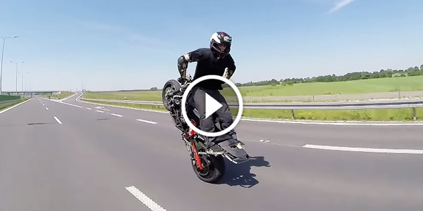 Crazy Guy Does Backwards Wheelie on Highway