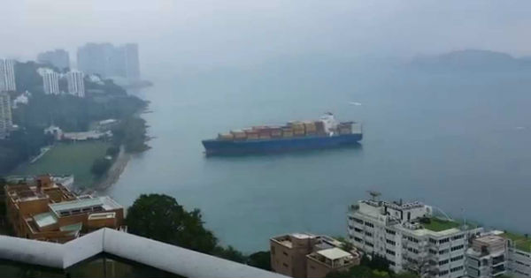 Container ship sails straight to shore by university football field 3