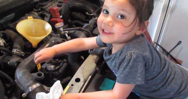 Little Girl Mechanic Changes Oil 2